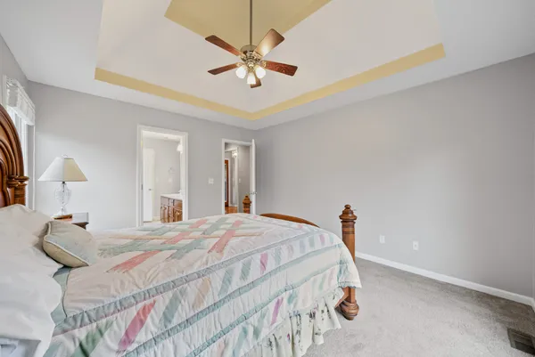 a bedroom with a bed and a chandelier