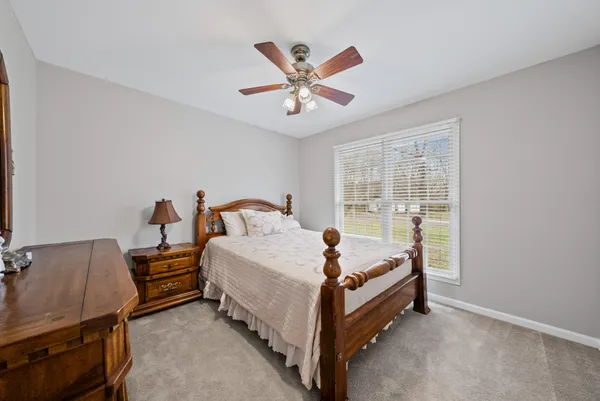 a bed room with a bed and ceiling fan