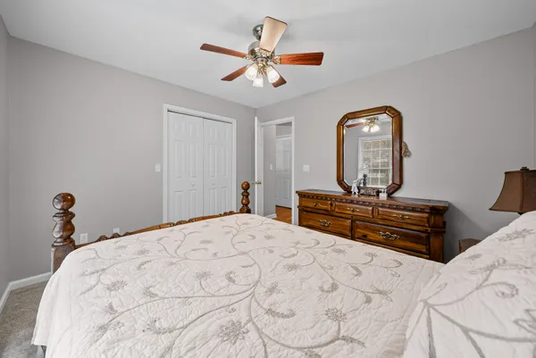a bedroom with a bed and a chandelier