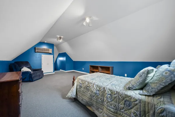a bedroom with a bed and a view of en suite bathroom