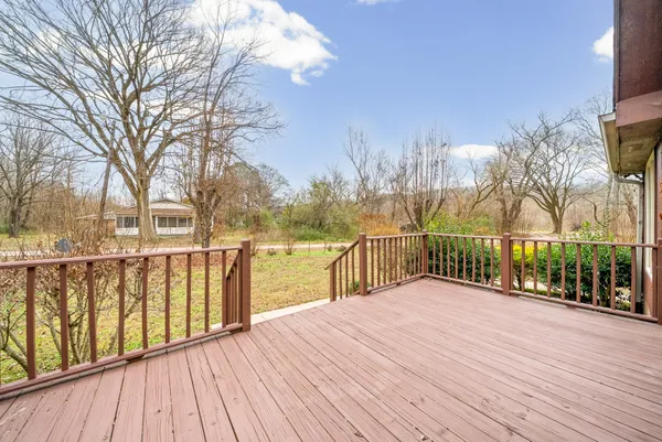 a balcony with view of trees in front of it