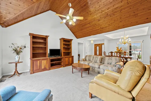 a living room with furniture and a chandelier