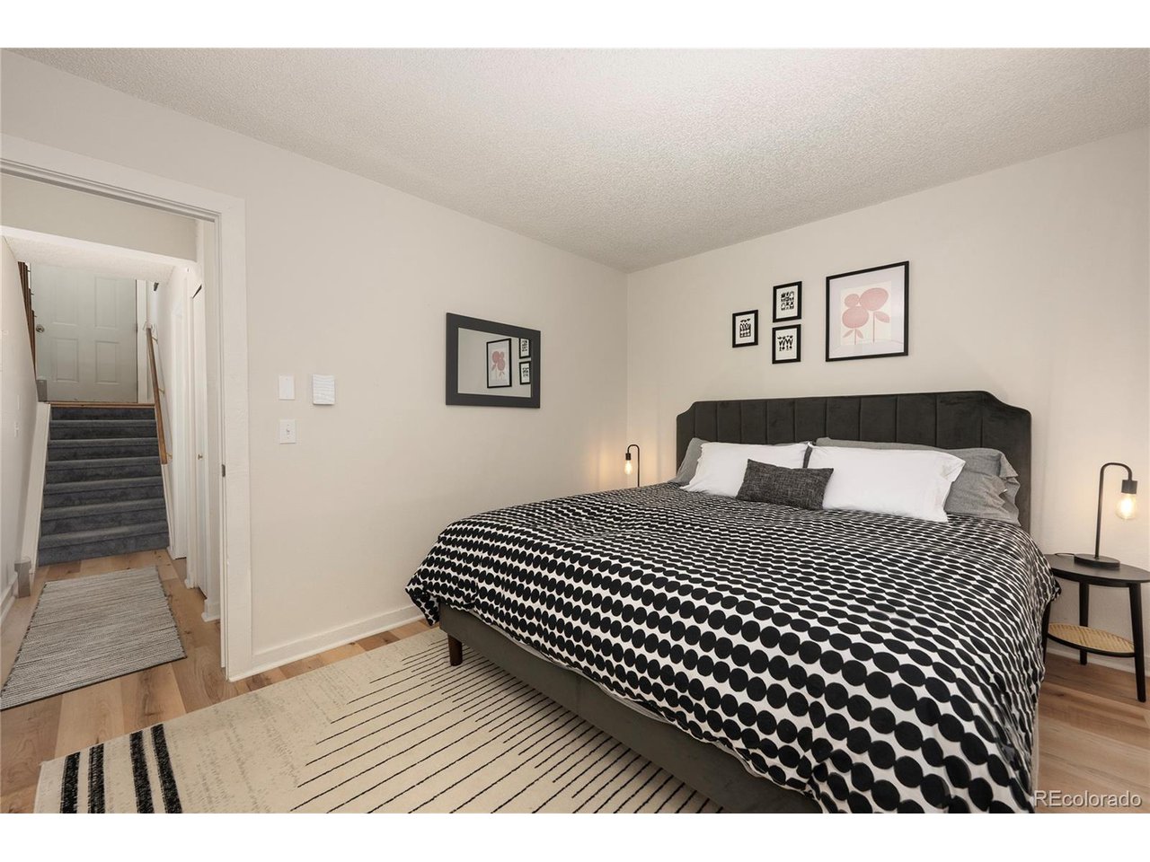 62 County Road 838, Unit 4 Fraser, CO 80442 - Photo 12 of 39 a bedroom with a bed and wooden floor