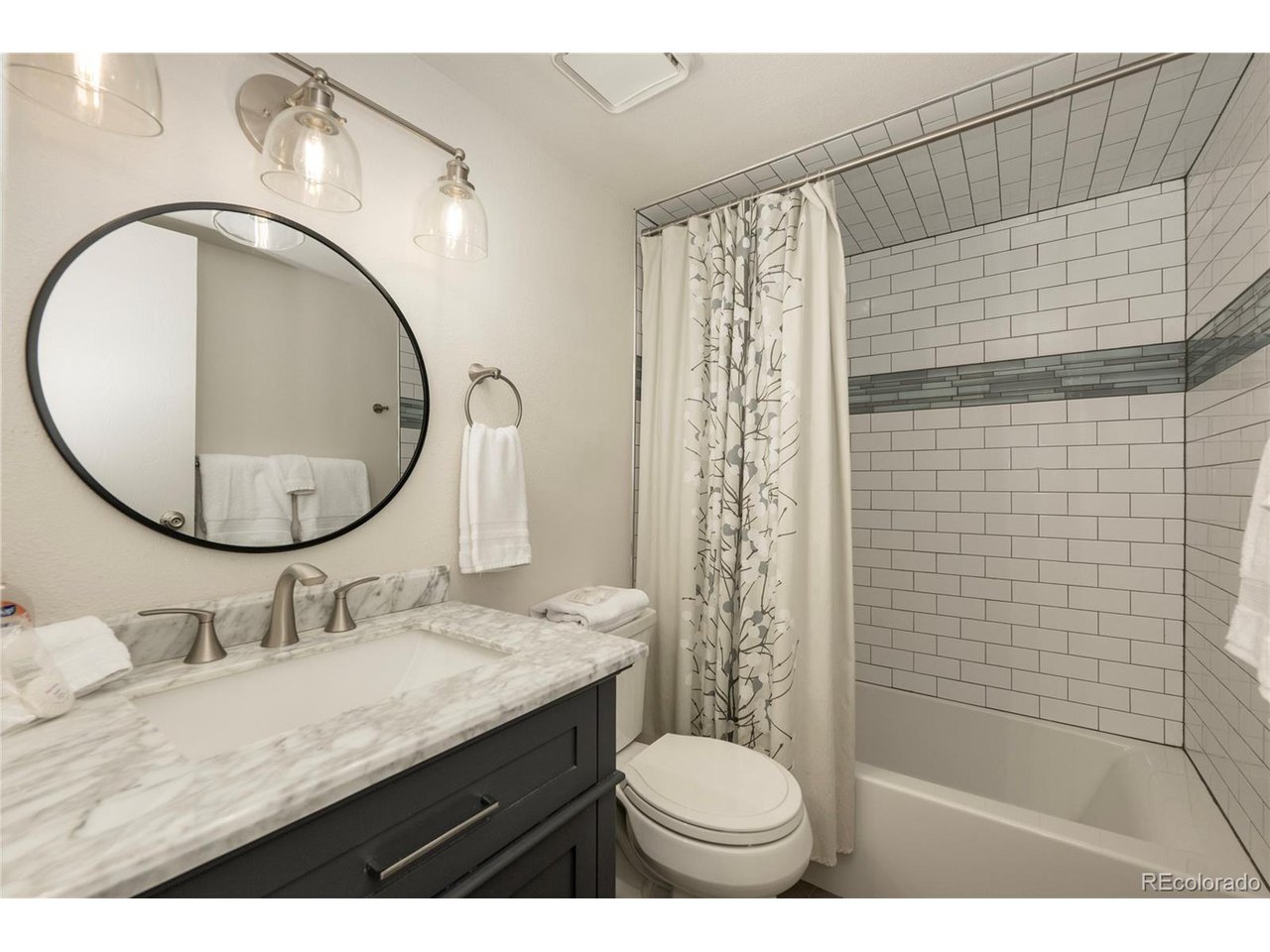62 County Road 838, Unit 4 Fraser, CO 80442 - Photo 15 of 39 a bathroom with a granite countertop sink toilet and a mirror