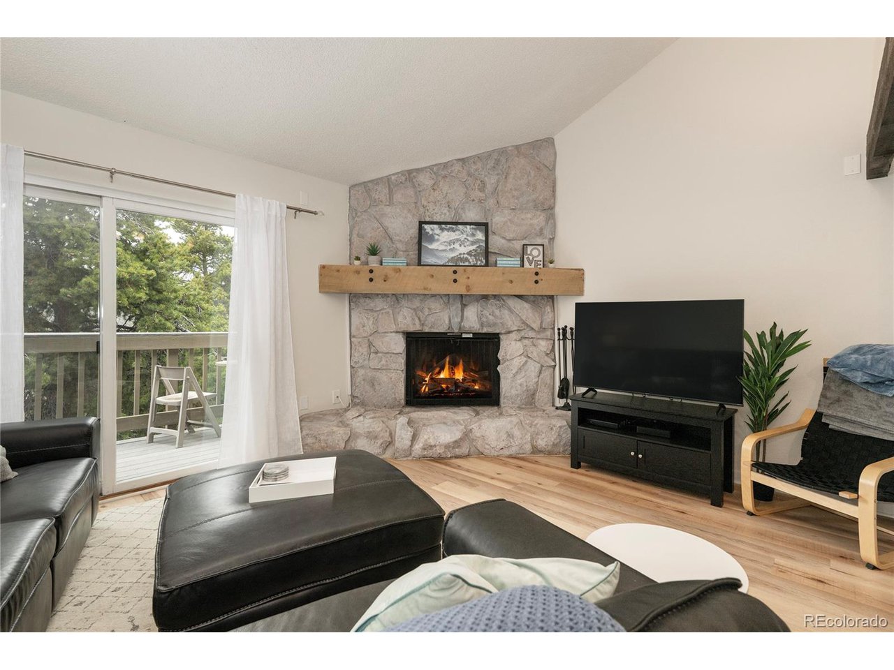 62 County Road 838, Unit 4 Fraser, CO 80442 - Photo 4 of 39 a living room with furniture and a fireplace