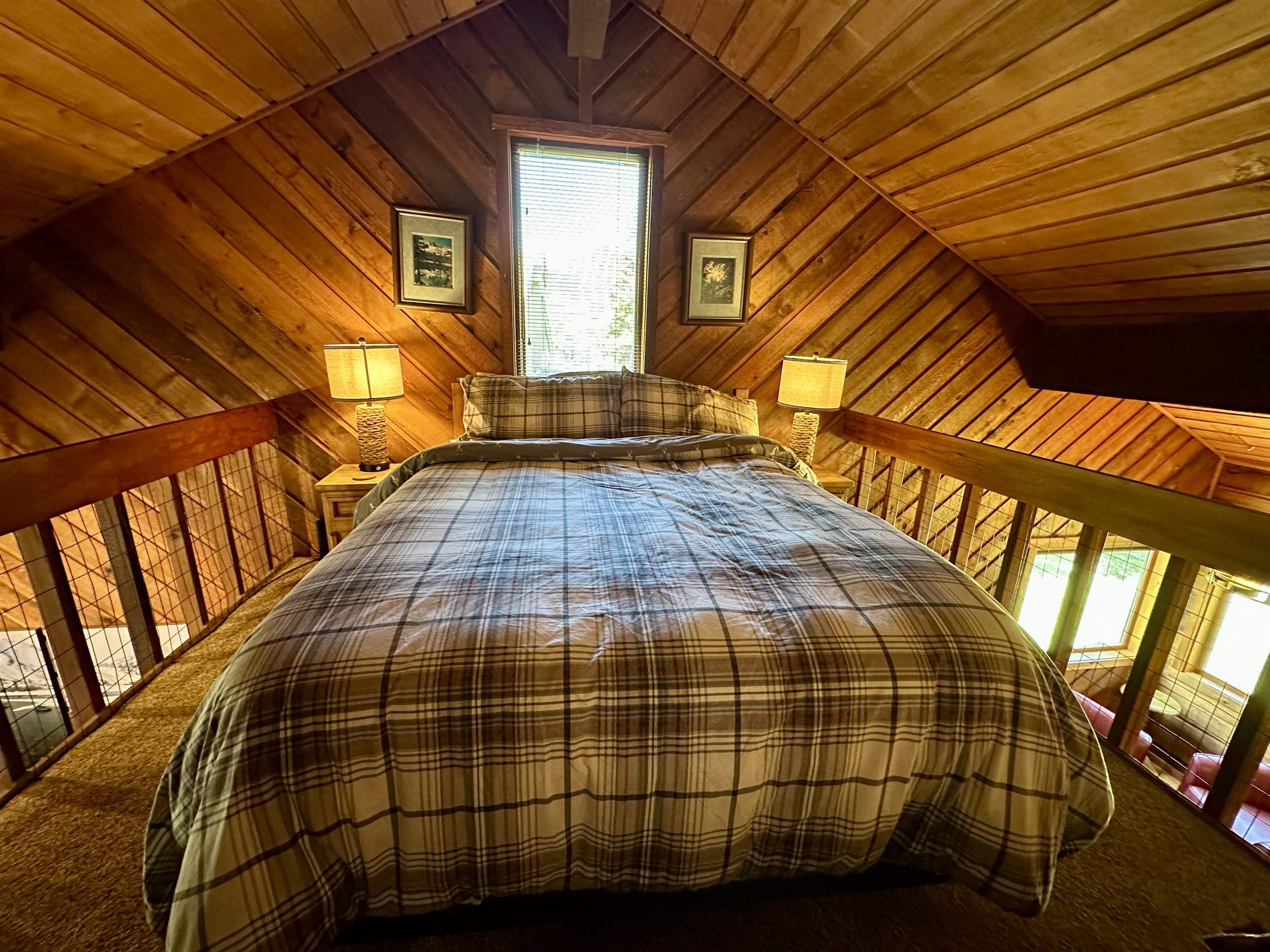 315 Fascination, Unit 315 Mammoth Lakes, CA 93546 - Photo 32 of 44 Loft bedroom with wood-paneled walls and ceiling, a single window, and textured carpeting