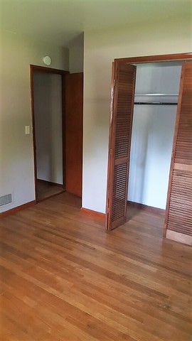 130 West Iowa Street Spring Valley, IL 61362 - Photo 4 of 7 a view of an empty room with wooden floor and closet
