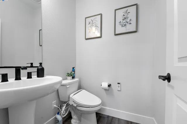 a bathroom with a sink mirror and toilet