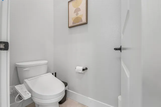 a white toilet sitting next to a shower