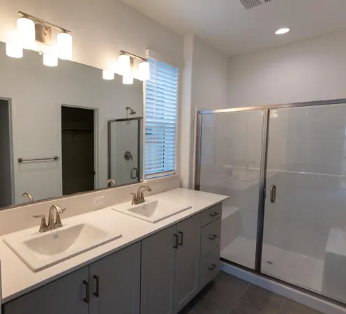 a bathroom with a double vanity sink mirror and double