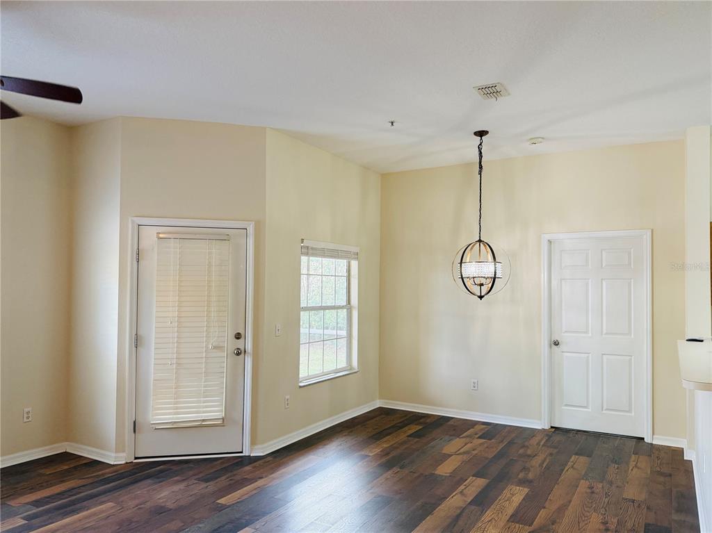 970 North Spring Garden Avenue, Unit 311 DeLand, FL 32720 - Photo 5 of 16 a view of an empty room with wooden floor and a window