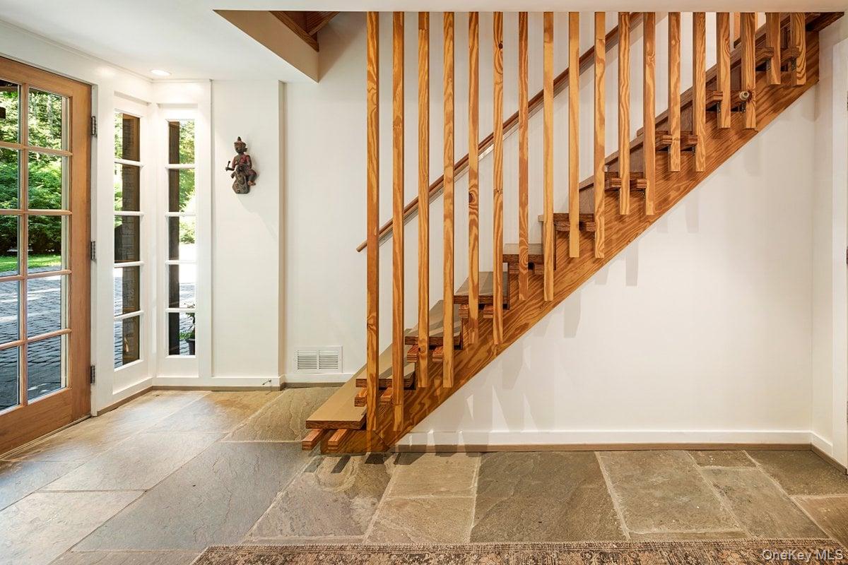 1821 Spring Valley Road Ossining, NY 10562 - Photo 4 of 48 Step into the stone-tiled foyer, through the glass front door where a beautiful wooden staircase welcomes you and leads you up to the main level..
