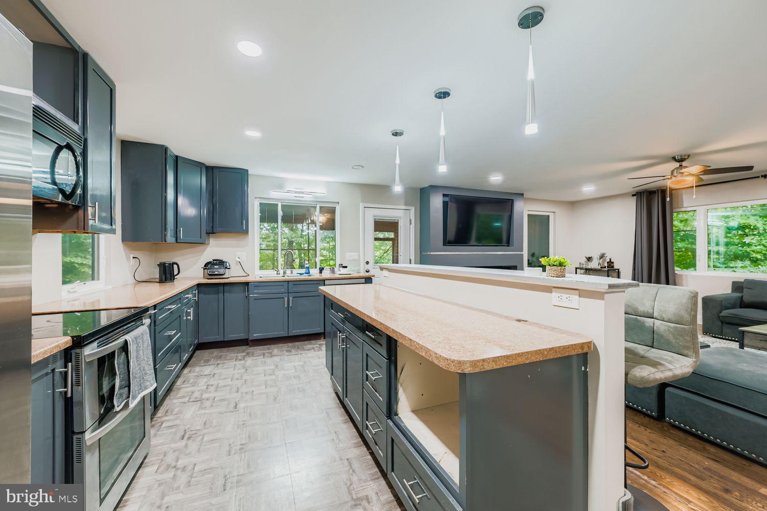 3203 Brezina Place Edgewater, MD 21037 - Photo 11 of 42 a large kitchen with stainless steel appliances kitchen island granite countertop a sink and cabinets