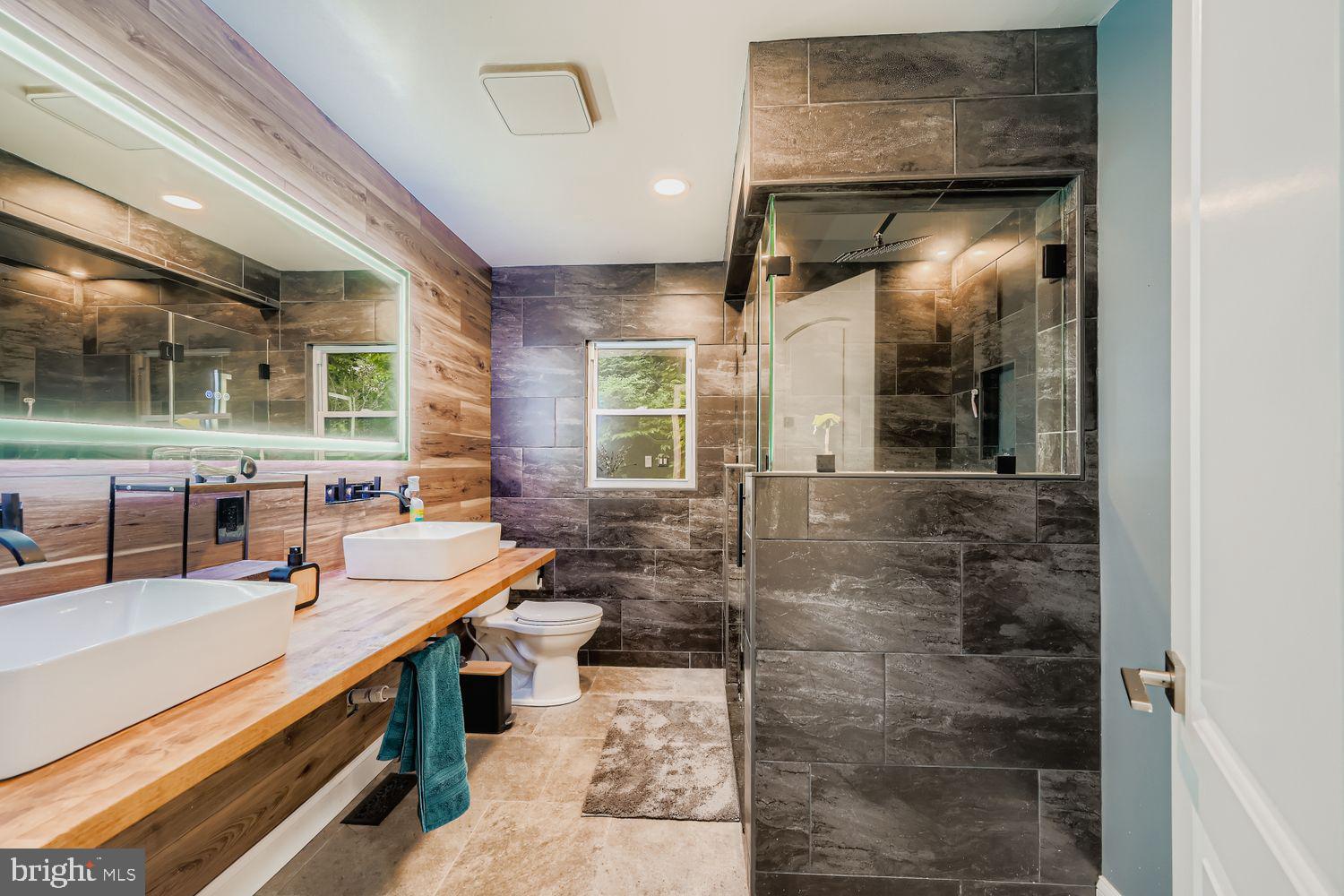 3203 Brezina Place Edgewater, MD 21037 - Photo 14 of 42 a bathroom with a sink a mirror and a shower