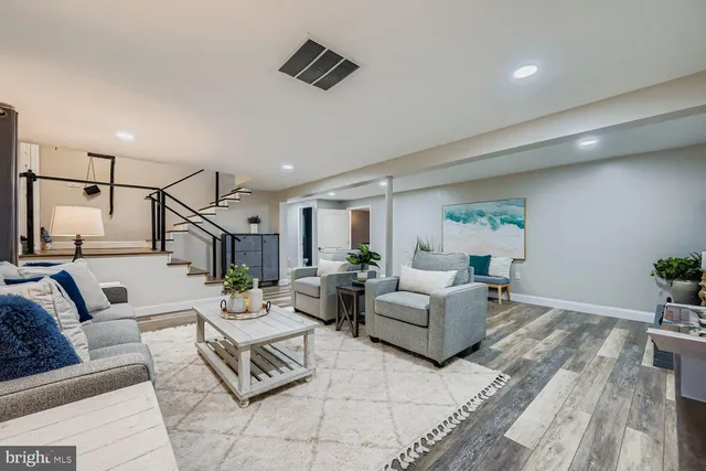 a living room with furniture and wooden floor