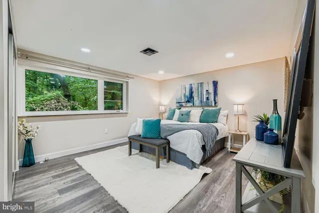 a bedroom with furniture and a large window