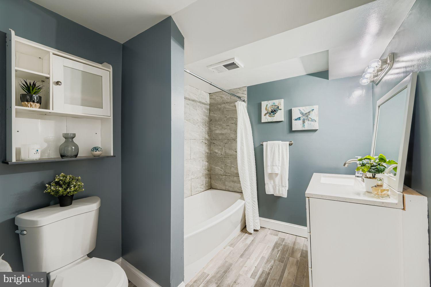 3203 Brezina Place Edgewater, MD 21037 - Photo 27 of 42 a white toilet sitting next to a bathroom sink