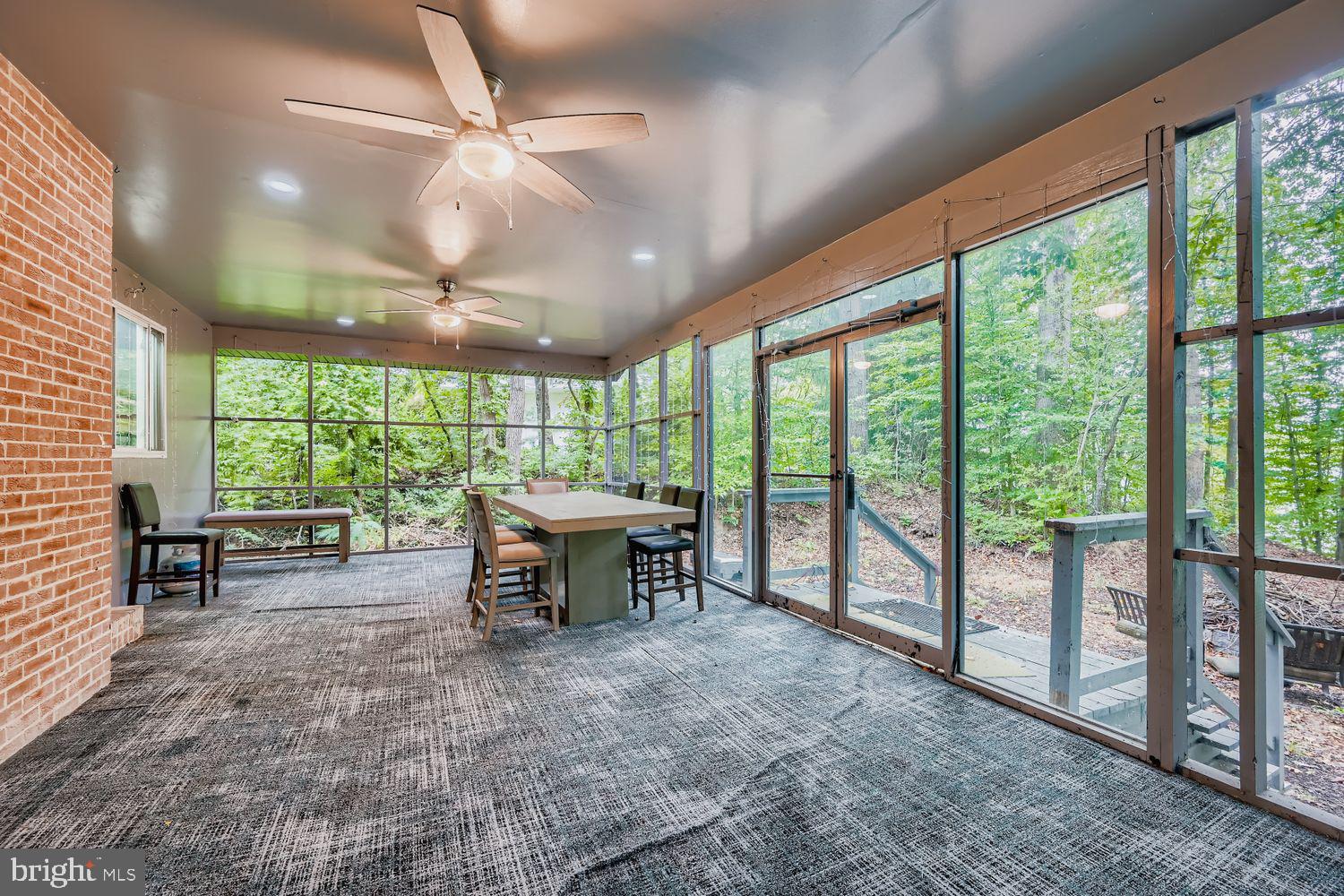 3203 Brezina Place Edgewater, MD 21037 - Photo 29 of 42 a view of a dining room with furniture large windows and wooden walls