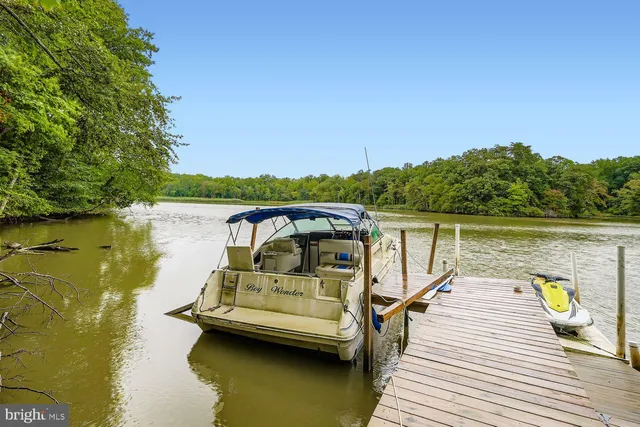 a view of a lake with couches chairs