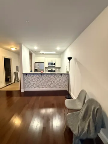 a view of a livingroom with furniture and a potted plant