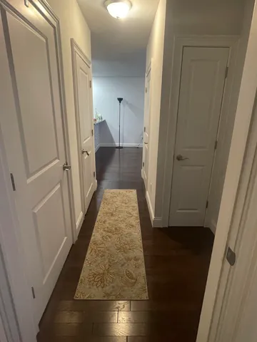 a view of hallway with wooden floor