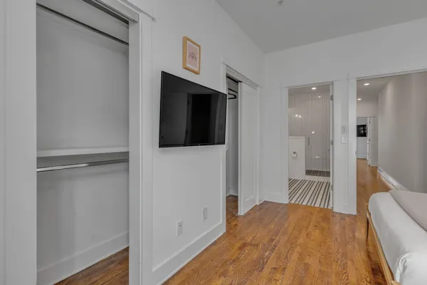 a bedroom with a bed and a mirror