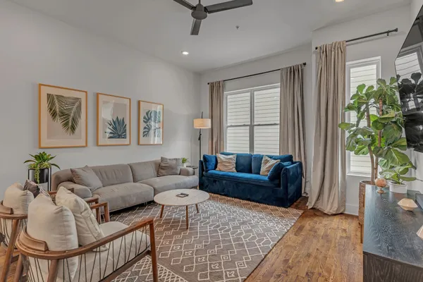 a living room with furniture and a potted plant