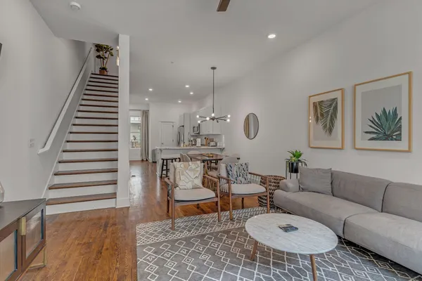 a living room with furniture and wooden floor