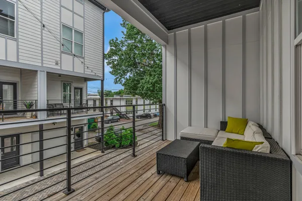 a view of balcony with couch and wooden floor