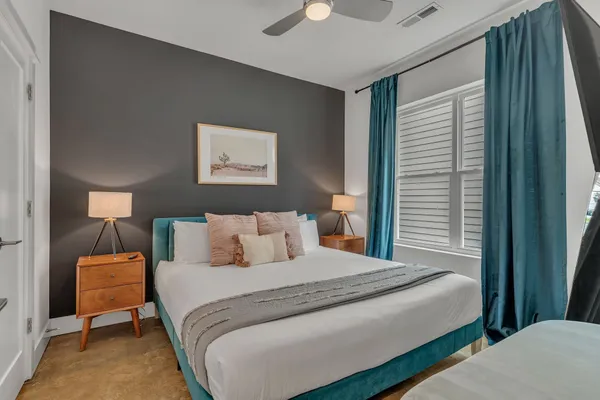 a bedroom with a bed and a lamp