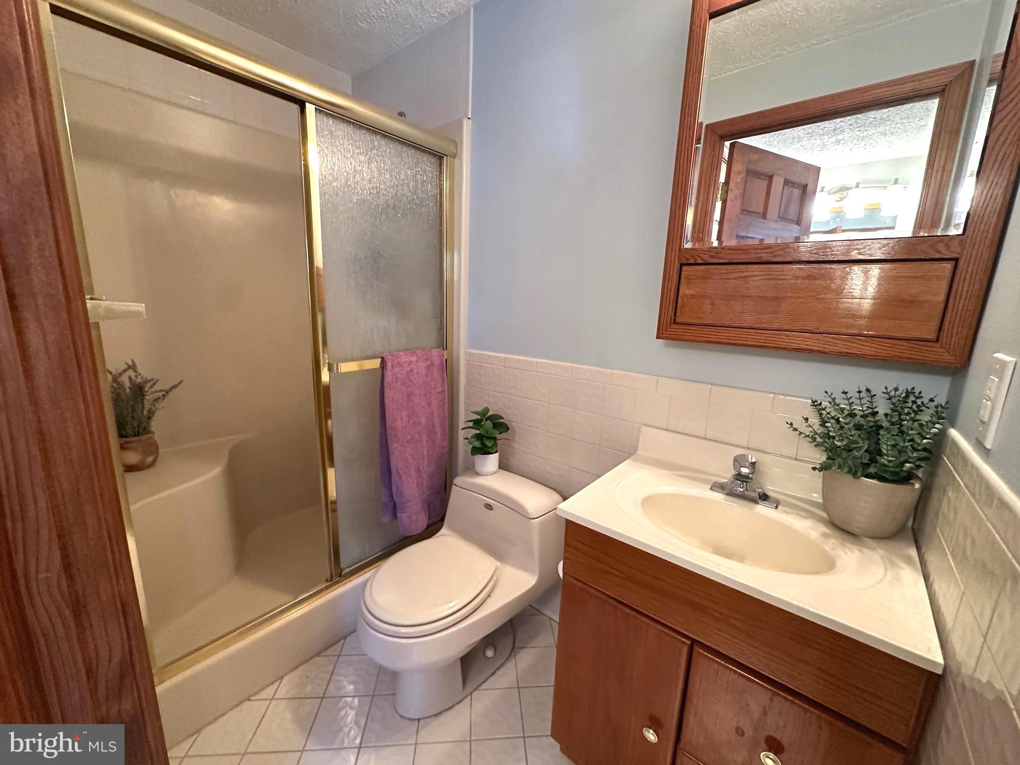 13 Cinder Road Lutherville-Timonium, MD 21093 - Photo 16 of 28 a bathroom with a sink a toilet and shower