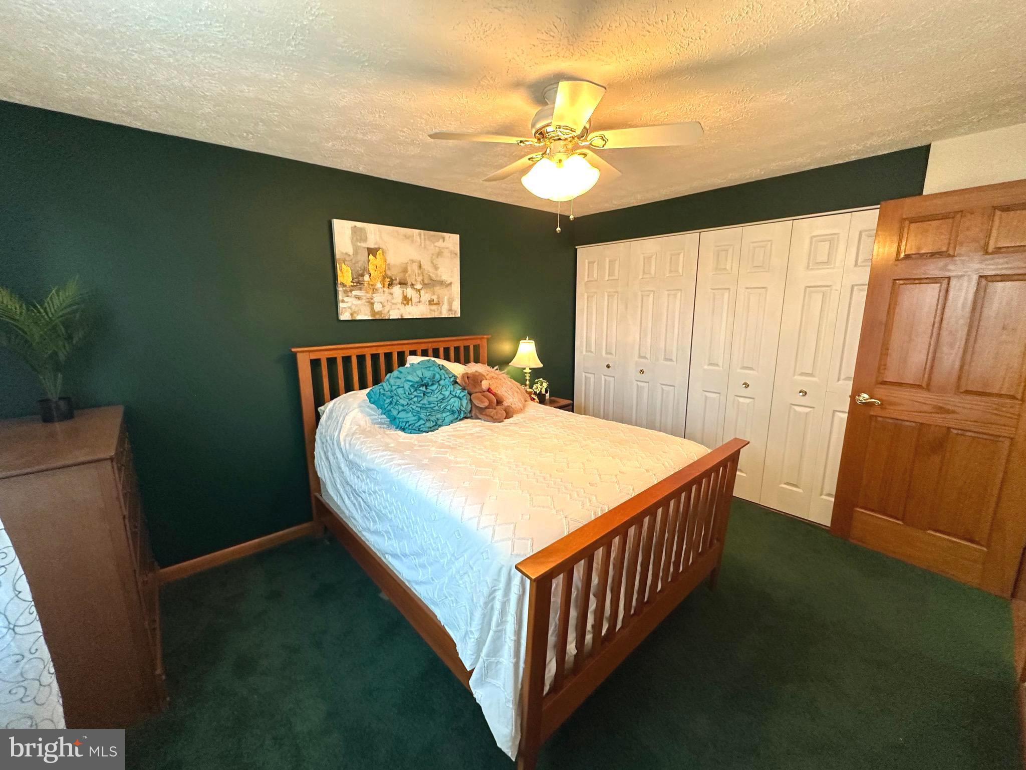13 Cinder Road Lutherville-Timonium, MD 21093 - Photo 18 of 28 a bedroom with a bed and a chandelier