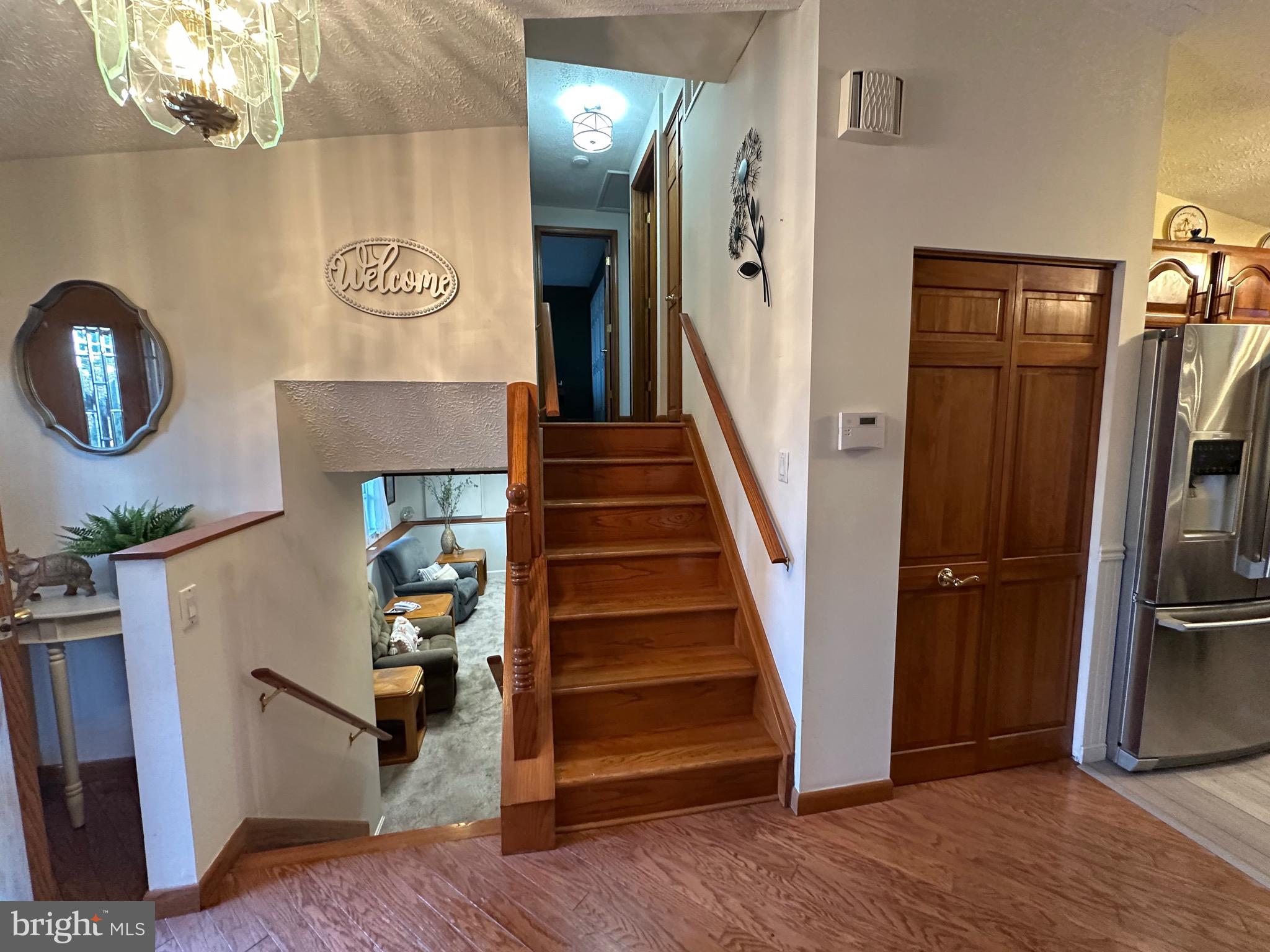13 Cinder Road Lutherville-Timonium, MD 21093 - Photo 9 of 28 a view of a livingroom with wooden floor and staircase
