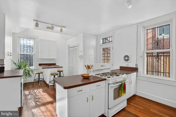 a kitchen that has a stove and a table in it