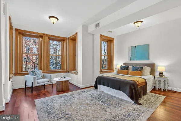 a bedroom with a large bed and a couch