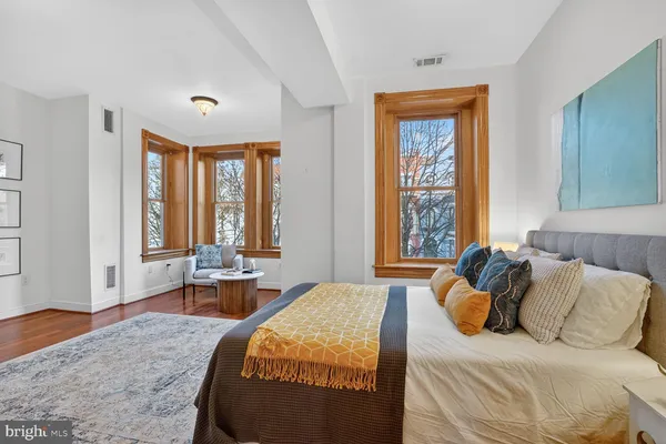 a bedroom with a bed and windows