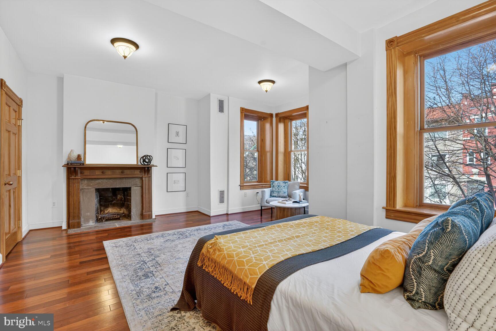 1634 R Street Northwest Washington, DC 20009 - Photo 19 of 30 a bedroom with a bed and a fireplace