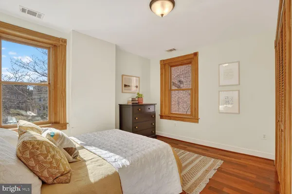 a bed sitting in a bedroom next to a window