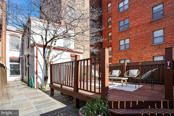 a backyard of a house with barbeque oven and bench