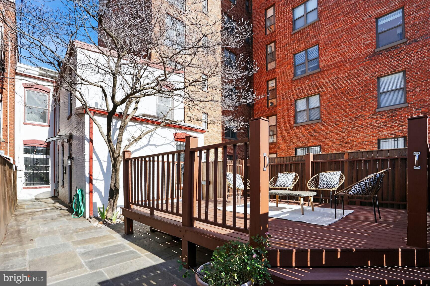 1634 R Street Northwest Washington, DC 20009 - Photo 28 of 30 a backyard of a house with barbeque oven and bench