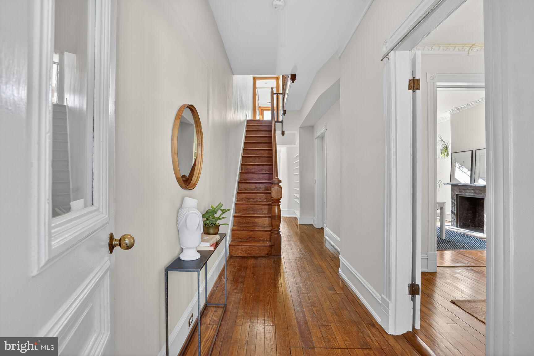 1634 R Street Northwest Washington, DC 20009 - Photo 4 of 30 a view of a hallway with wooden floor and staircase