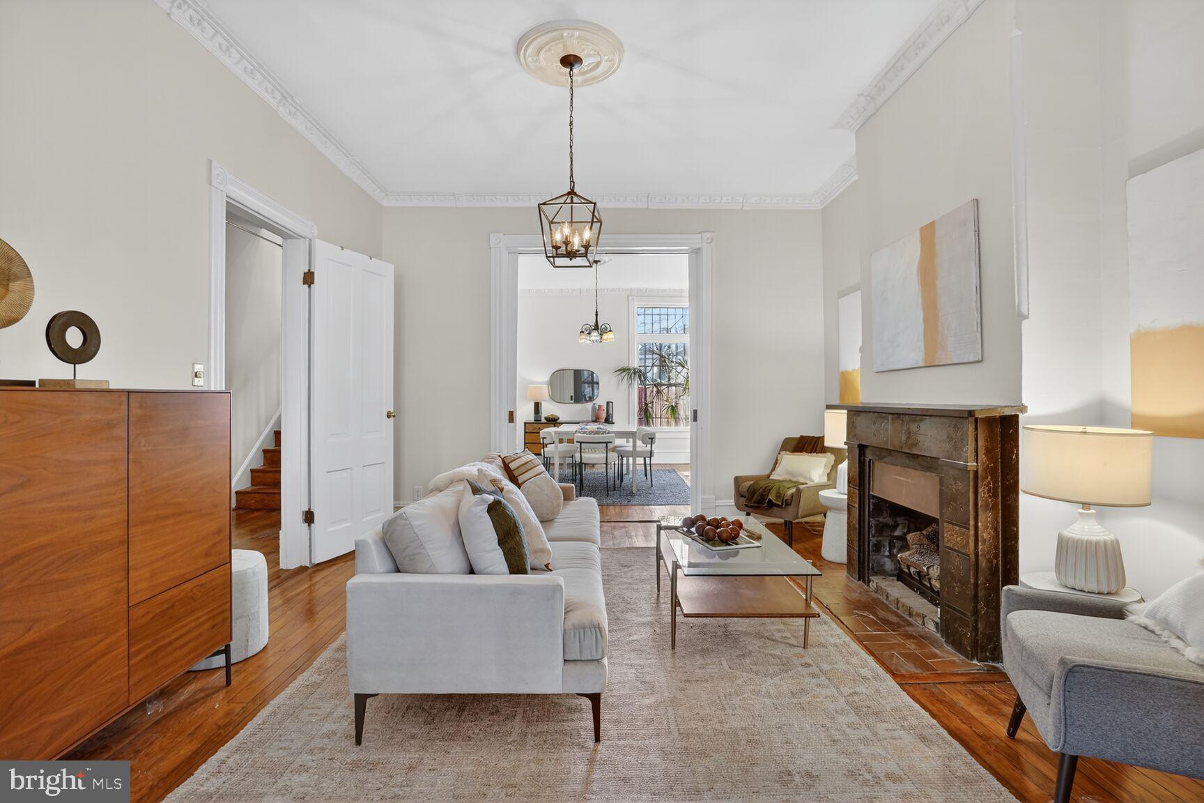 1634 R Street Northwest Washington, DC 20009 - Photo 5 of 30 a living room with furniture a fireplace and a chandelier