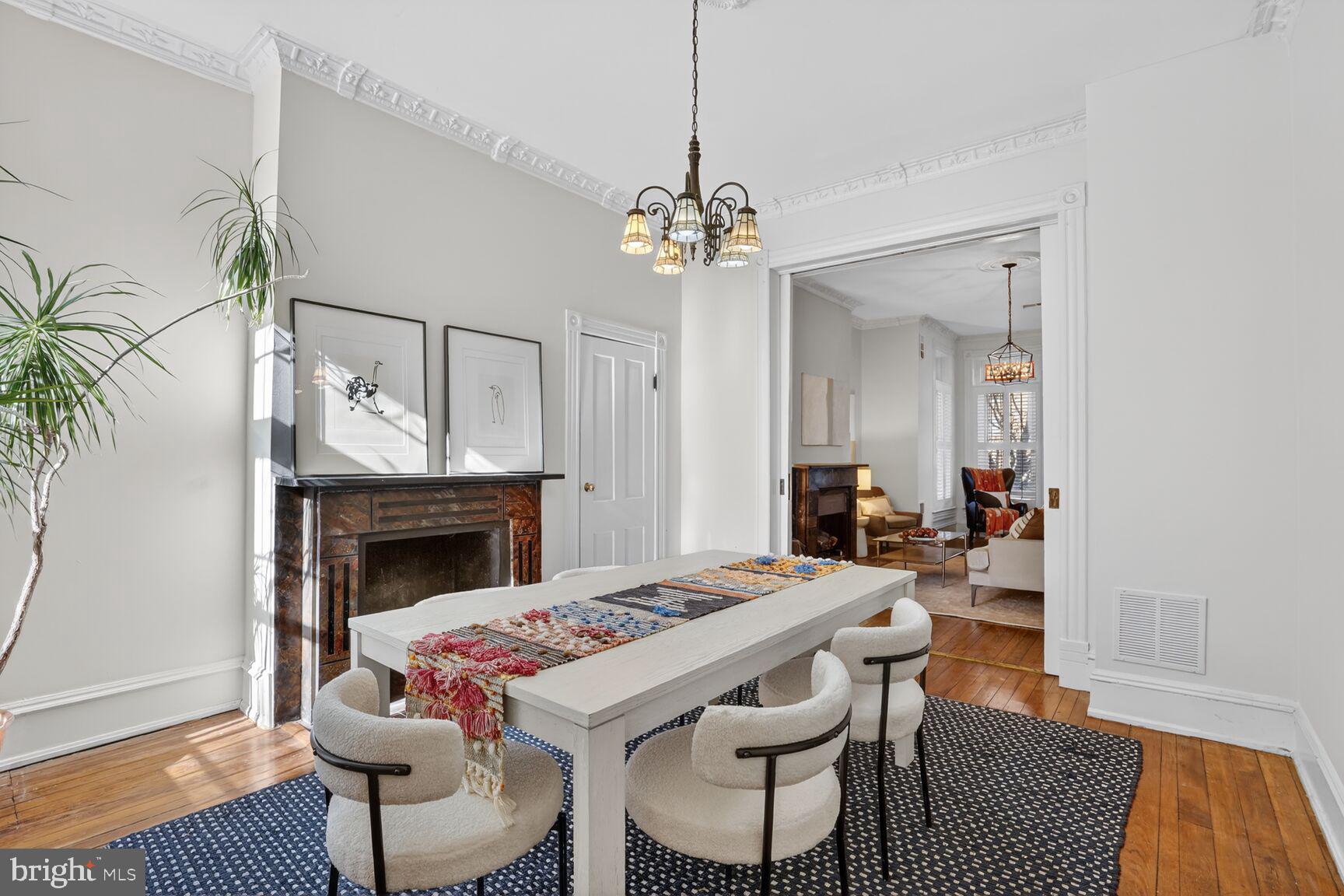 1634 R Street Northwest Washington, DC 20009 - Photo 6 of 30 a dining room with furniture a fireplace and wooden floor