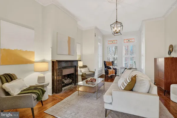 a living room with furniture fireplace and a window