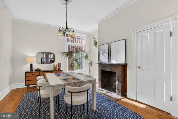 a view of a dining room with furniture wooden floor and a chandelier
