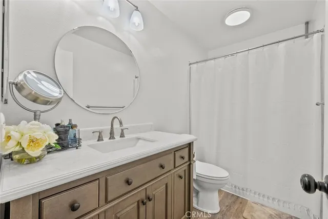 a kitchen with stainless steel appliances kitchen island granite countertop a refrigerator and cabinets