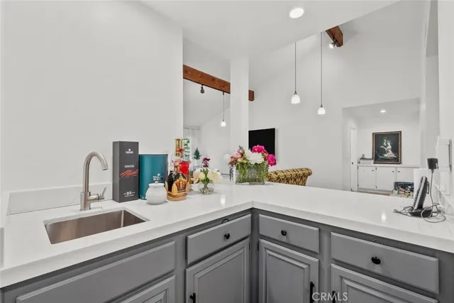 a kitchen with granite countertop appliances a sink and cabinets