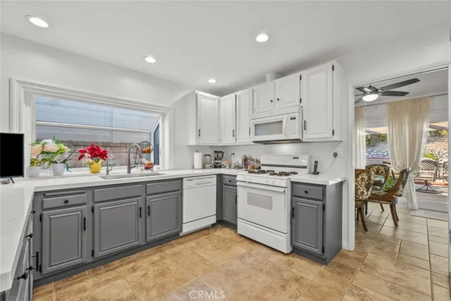 a kitchen with stainless steel appliances a refrigerator sink and stove