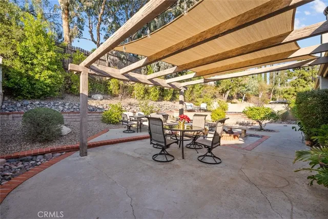a backyard of a house with table and chairs