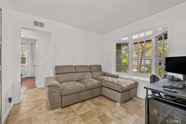 a living room with a bed furniture and a window